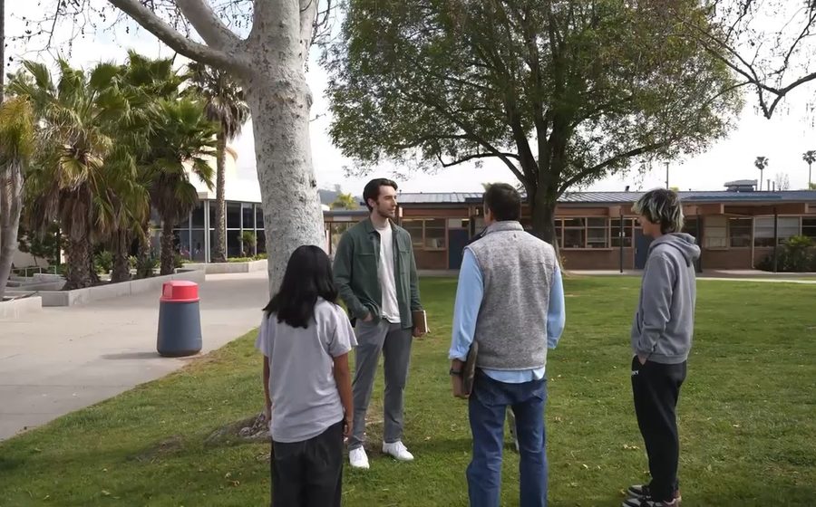 Parents and students talking together outside on campus