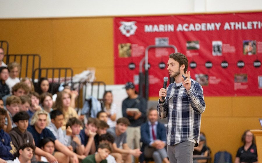 A Project Reboot speaker presenting to students at a school assembly