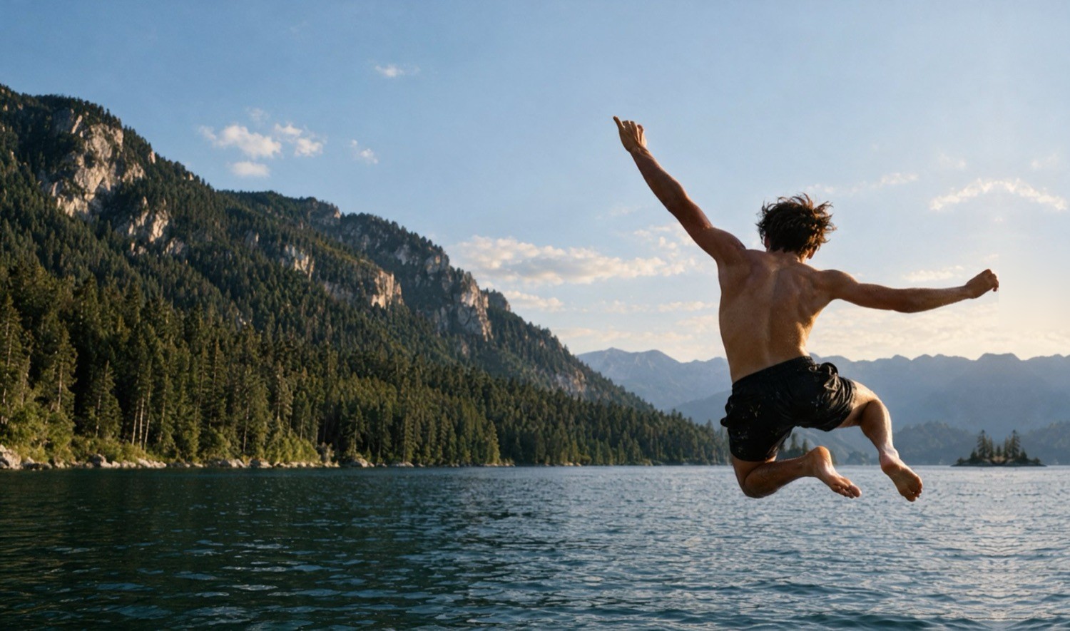 A student leaping into a mountain lake
